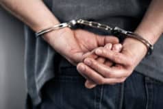 In handcuffs being extradited